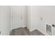 Laundry room with white door and grey vinyl flooring at 55 Locust Loop Cir, Ocala, FL 34472