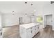 Bright, open living room next to kitchen with center island, ceiling fan and recessed lighting at 55 Locust Loop Cir, Ocala, FL 34472