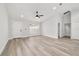 Bright living room boasts neutral paint, ceiling fan, and luxury vinyl plank flooring at 55 Locust Loop Cir, Ocala, FL 34472