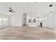 Open-concept living room and kitchen with white cabinets, stainless appliances, and a modern island at 55 Locust Loop Cir, Ocala, FL 34472