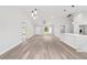 Bright living room features luxury vinyl plank flooring, white cabinets, and a modern island at 55 Locust Loop Cir, Ocala, FL 34472