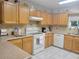 Well-equipped kitchen with light wood cabinets and granite countertops at 5555 Sw 107Th St, Ocala, FL 34476