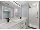 Modern bathroom with double vanity, marble shower, and black fixtures at 7 Hemlock Radial, Ocala, FL 34472