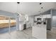 Bright kitchen with white cabinets, island, and stainless steel appliances at 7 Hemlock Radial, Ocala, FL 34472