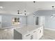 Modern kitchen island with white cabinets and quartz countertops at 7 Hemlock Radial, Ocala, FL 34472