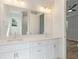 Double vanity bathroom with a large mirror and white cabinets at 7323 Sw 204Th Ave, Dunnellon, FL 34431