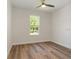 Bedroom with wood-look floors and ceiling fan at 7323 Sw 204Th Ave, Dunnellon, FL 34431