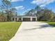 Single story home with three car garage and large driveway at 7323 Sw 204Th Ave, Dunnellon, FL 34431