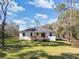 Rear view of house with deck and large backyard at 7323 Sw 204Th Ave, Dunnellon, FL 34431