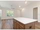 Kitchen island with white countertops and wooden cabinetry at 7323 Sw 204Th Ave, Dunnellon, FL 34431