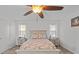 Bright bedroom with ceiling fan, double bed, and two nightstands at 7885 Sw 202Nd Ave, Dunnellon, FL 34431