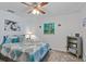 Bedroom with ceiling fan, bookshelf, and a queen-size bed at 7885 Sw 202Nd Ave, Dunnellon, FL 34431