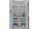 Built-in shelving unit with books, decorative items, and storage bins at 7885 Sw 202Nd Ave, Dunnellon, FL 34431