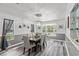 Bright dining room features a wood table, gray chairs, and wood-look flooring at 7885 Sw 202Nd Ave, Dunnellon, FL 34431