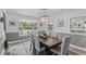 Dining room with a wood table, gray chairs, and large windows at 7885 Sw 202Nd Ave, Dunnellon, FL 34431