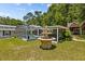 Two-tiered stone fountain in the backyard with lush landscaping at 7885 Sw 202Nd Ave, Dunnellon, FL 34431