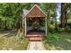 Wooden gazebo with grill and seating area at 7885 Sw 202Nd Ave, Dunnellon, FL 34431