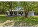 Gray house with black shutters and landscaping at 7885 Sw 202Nd Ave, Dunnellon, FL 34431