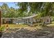 Back exterior of the house overlooking the pool and patio at 7885 Sw 202Nd Ave, Dunnellon, FL 34431