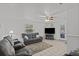 Living room with gray reclining sofas, ceiling fan, and a flat-screen TV at 7885 Sw 202Nd Ave, Dunnellon, FL 34431