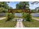 Wooden pergola with seating area and lush greenery at 7885 Sw 202Nd Ave, Dunnellon, FL 34431