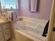 Bathroom with soaking tub and tile surround at 8187 Sw 60Th Ter, Ocala, FL 34476