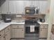 Modern kitchen with stainless steel appliances and wood cabinets at 8187 Sw 60Th Ter, Ocala, FL 34476