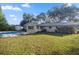 Backyard view of home with pool and grassy area at 820 Ne 42Nd Ter, Ocala, FL 34470