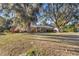 Brick ranch house with mature landscaping and large oak trees at 820 Ne 42Nd Ter, Ocala, FL 34470