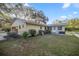 House exterior with side yard and partial view of pool at 820 Ne 42Nd Ter, Ocala, FL 34470