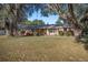 Brick ranch home with a large yard and mature trees at 820 Ne 42Nd Ter, Ocala, FL 34470