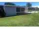 A covered outdoor patio in the backyard provides a perfect spot for relaxation and entertaining at 8973 Sw 101St Ln, Ocala, FL 34481
