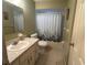 Bathroom featuring a single sink vanity and a shower tub combo at 8973 Sw 101St Ln, Ocala, FL 34481