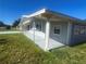 Exterior side view of home, showing covered patio and well-kept lawn at 8973 Sw 101St Ln, Ocala, FL 34481