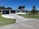 Charming single-story home with carport and screened porch, set on a well-maintained lot at 8973 Sw 101St Ln, Ocala, FL 34481