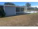 House exterior with covered patio and grassy yard at 8973 Sw 101St Ln, Ocala, FL 34481