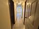 Long hallway with tile floors and access to bedrooms at 8973 Sw 101St Ln, Ocala, FL 34481