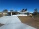 Front view of a ranch home with a carport at 8973 Sw 101St Ln, Ocala, FL 34481