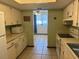 View of kitchen with white cabinets and view to living room at 8973 Sw 101St Ln, Ocala, FL 34481