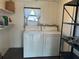 Laundry room with washer, dryer, and storage shelving at 8973 Sw 101St Ln, Ocala, FL 34481