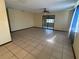 Spacious living room with tile flooring and sliding glass doors to the outside at 8973 Sw 101St Ln, Ocala, FL 34481