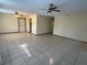 Open-concept living room featuring tile flooring, ceiling fan, and neutral color palette at 8973 Sw 101St Ln, Ocala, FL 34481
