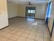 Spacious living room with tiled floors and sliding glass door at 8973 Sw 101St Ln, Ocala, FL 34481