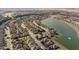 Aerial view of a residential community with houses and a lake at 9211 Sw 66Th Loop, Ocala, FL 34481