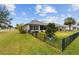 House with fenced backyard, grassy lawn, and street view at 9211 Sw 66Th Loop, Ocala, FL 34481