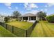 Home with fenced backyard, lush lawn, and partial view of house at 9211 Sw 66Th Loop, Ocala, FL 34481