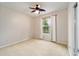 Well-lit bedroom featuring carpet flooring and large window at 9211 Sw 66Th Loop, Ocala, FL 34481