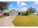 One-story home with a gray garage door and well-manicured lawn at 9211 Sw 66Th Loop, Ocala, FL 34481