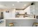 Modern kitchen featuring white cabinets, stainless steel appliances, and a breakfast bar at 9211 Sw 66Th Loop, Ocala, FL 34481