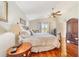 Bright bedroom featuring a king-size bed and wood floors at 9267 Sw 91St Cir, Ocala, FL 34481